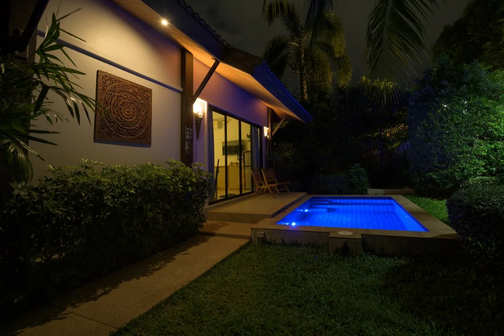 One-bedroom villa garden and pool at night