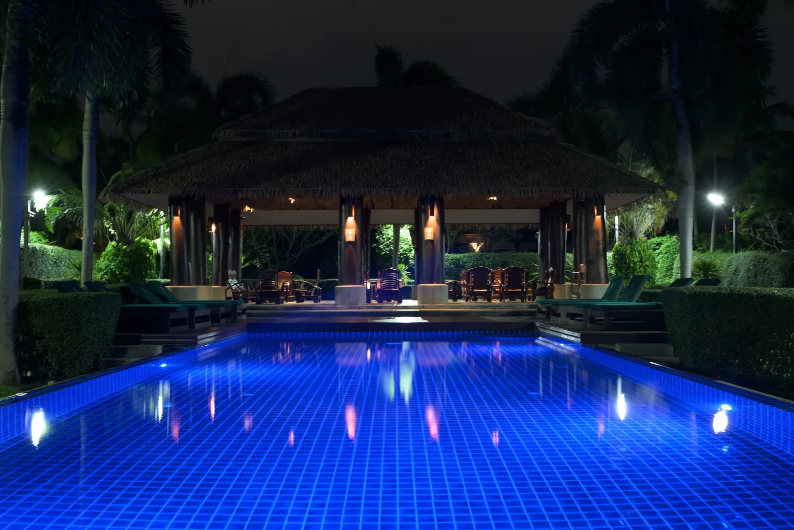 Shared pool lit up at night at Green Garden Villas